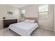 Neutral bedroom with large windows, tiled floor, and plush king bed at 4424 W Vervain Ave, San Tan Valley, AZ 85144
