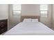 Neutral bedroom with large windows, tiled floor, and plush king bed at 4424 W Vervain Ave, San Tan Valley, AZ 85144