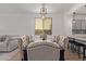 Dining room with an elegant table set for eight and a view into the open kitchen at 4424 W Vervain Ave, San Tan Valley, AZ 85144