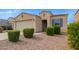 Welcoming single-story home with desert landscaping, a two-car garage, and a 'WELCOME' door sign at 4424 W Vervain Ave, San Tan Valley, AZ 85144