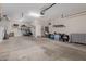 Large garage with shelving, refrigerator, and lots of storage space at 4424 W Vervain Ave, San Tan Valley, AZ 85144