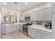 Modern kitchen features stainless steel appliances, light gray cabinetry, and mosaic tile backsplash at 4424 W Vervain Ave, San Tan Valley, AZ 85144