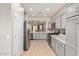 Well-lit modern kitchen featuring stainless steel appliances and gray cabinets at 4424 W Vervain Ave, San Tan Valley, AZ 85144