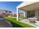 Inviting outdoor living space with covered patio, green turf and a view of the backyard pool at 5330 W Thresher Way, Laveen, AZ 85339