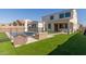 Beautiful backyard features a pool, patio area with seating, and well-maintained artificial turf at 5330 W Thresher Way, Laveen, AZ 85339