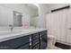 Modern bathroom features a double sink vanity with white countertop and neutral-colored tile flooring at 5330 W Thresher Way, Laveen, AZ 85339