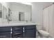 Modern bathroom with double sinks, vanity area, stylish fixtures, and a large mirror at 5330 W Thresher Way, Laveen, AZ 85339