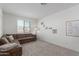 Cozy bedroom with plush carpet, comfortable sofa, and a window with neighborhood views at 5330 W Thresher Way, Laveen, AZ 85339