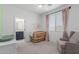 Charming Bedroom with crib, neutral walls, and cozy chair creating a peaceful environment at 5330 W Thresher Way, Laveen, AZ 85339