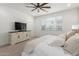 Inviting bedroom featuring plush bedding, neutral decor, and a ceiling fan at 5330 W Thresher Way, Laveen, AZ 85339