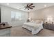 Bright bedroom featuring a ceiling fan, neutral color palette and large window for natural light at 5330 W Thresher Way, Laveen, AZ 85339