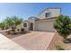 Charming two-story home with a two-car garage and desert landscaping at 5330 W Thresher Way, Laveen, AZ 85339