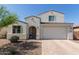 Charming two-story home with a two-car garage and desert landscaping at 5330 W Thresher Way, Laveen, AZ 85339