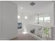 Bright hallway with natural light, carpet and white railing overlooking the living room at 5330 W Thresher Way, Laveen, AZ 85339