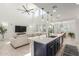 Bright, modern kitchen with an island overlooking the living area, enhancing the home's open feel at 5330 W Thresher Way, Laveen, AZ 85339