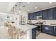 Well-lit kitchen with an island, stainless steel appliances, and blue cabinets at 5330 W Thresher Way, Laveen, AZ 85339