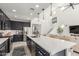 Open kitchen with an island, stainless steel appliances, and a view of the living room at 5330 W Thresher Way, Laveen, AZ 85339
