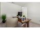 Clean and modern office space with a large desk and neutral decor at 5330 W Thresher Way, Laveen, AZ 85339