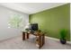 Bright and airy office space with a green accent wall and natural light at 5330 W Thresher Way, Laveen, AZ 85339