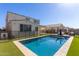 Backyard pool featuring pool, patio area with seating, and well-maintained artificial turf at 5330 W Thresher Way, Laveen, AZ 85339