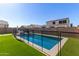 Backyard with a fenced pool and green turf, creating a refreshing outdoor oasis at 5330 W Thresher Way, Laveen, AZ 85339