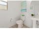 Elegant powder room featuring a pedestal sink, modern fixtures, and neutral decor at 5330 W Thresher Way, Laveen, AZ 85339