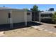 Cozy backyard patio with a covered area, a mix of concrete and gravel surfaces, and a few plants around the fence at 5342 E Des Moines St, Mesa, AZ 85205