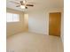 Bedroom features tile floors, neutral walls, ceiling fan and a window providing lots of light at 5342 E Des Moines St, Mesa, AZ 85205
