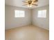 Bedroom features tile floors, neutral walls, ceiling fan and two windows providing lots of light at 5342 E Des Moines St, Mesa, AZ 85205
