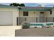 Charming single-story home with front gate, desert landscaping, and white exterior at 5342 E Des Moines St, Mesa, AZ 85205