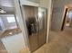 Stainless steel refrigerator adds a modern touch to the kitchen space with tile flooring, ideal for Gathering living at 5342 E Des Moines St, Mesa, AZ 85205