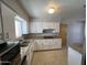 Spacious kitchen featuring updated appliances, white cabinets, and granite countertops at 5342 E Des Moines St, Mesa, AZ 85205