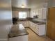 Well-lit kitchen features granite countertops, stainless steel appliances, and tile flooring perfect for everyday living at 5342 E Des Moines St, Mesa, AZ 85205