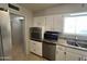Bright kitchen featuring white cabinets, stainless steel appliances, and granite countertops, ready for cooking enjoyment at 5342 E Des Moines St, Mesa, AZ 85205
