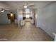 Open floorplan showcasing the living room and kitchen with tile flooring and a ceiling fan, great for entertaining at 5342 E Des Moines St, Mesa, AZ 85205