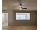 Bright living space with tile floors and a ceiling fan creates a comfortable and inviting atmosphere for relaxation at 5342 E Des Moines St, Mesa, AZ 85205
