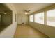 Bright sunroom features tile flooring, ceiling fan, and several windows for ample natural light at 5342 E Des Moines St, Mesa, AZ 85205