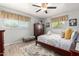 Inviting bedroom with a ceiling fan, natural light, and a comfortable, stylish bed at 701 N 55Th Pl, Mesa, AZ 85205