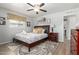 Cozy bedroom featuring a decorative ceiling fan, soft lighting, and a well-appointed bed at 701 N 55Th Pl, Mesa, AZ 85205