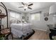 Bright bedroom with a decorative bed frame, natural light, and stylish window coverings at 701 N 55Th Pl, Mesa, AZ 85205