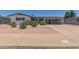 Charming single-story home featuring desert landscaping, a carport, and fresh, white paint in a well-maintained neighborhood at 701 N 55Th Pl, Mesa, AZ 85205