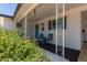 Inviting front porch with decorative white pillars, cozy seating, and a vibrant turquoise door, creating a welcoming entrance at 701 N 55Th Pl, Mesa, AZ 85205