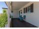 Comfortable covered front porch with seating and charming decor, offering a relaxing outdoor space with neighborhood views at 701 N 55Th Pl, Mesa, AZ 85205