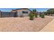 A low-maintenance desert landscape adds to the curb appeal of this charming, single-story residence with a painted brick exterior at 701 N 55Th Pl, Mesa, AZ 85205