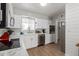 Well-lit kitchen with white cabinetry, stainless steel appliances, and sleek countertops at 701 N 55Th Pl, Mesa, AZ 85205