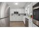 Well-equipped kitchen boasting white cabinets, stainless steel appliances, and modern design at 701 N 55Th Pl, Mesa, AZ 85205