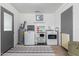 Functional laundry room with washer, dryer, and ample storage space at 701 N 55Th Pl, Mesa, AZ 85205