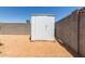 Exterior shot of a metal shed with a level, dirt and gravel surround at 701 N 55Th Pl, Mesa, AZ 85205