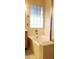 A bathtub sits beside a window and glass shower doors in this serene bathroom at 7825 W Crocus Dr, Peoria, AZ 85381