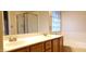 Well-lit bathroom featuring a bathtub and dual vanity sinks, offering a spacious design at 7825 W Crocus Dr, Peoria, AZ 85381